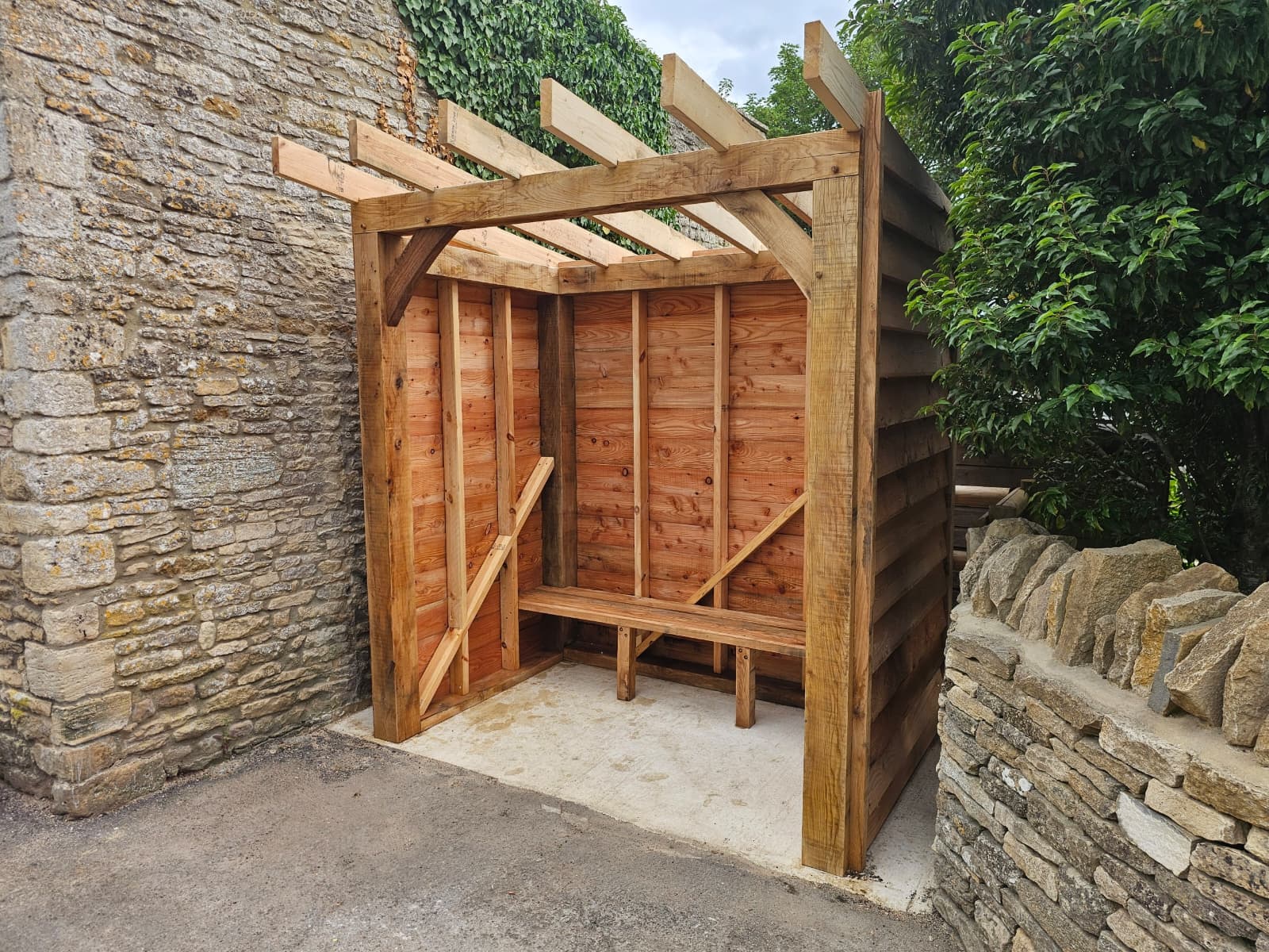 Completed small oak frame log store and shelter structure