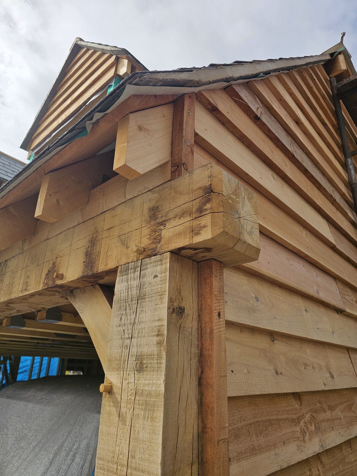 Exposed rafter feet projecting over the oak wall plate at the eaves